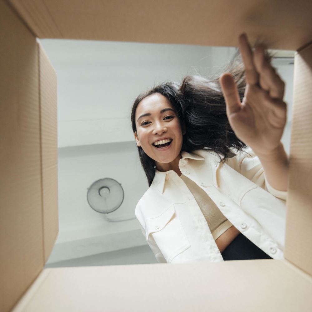 Smiling woman looking down into box