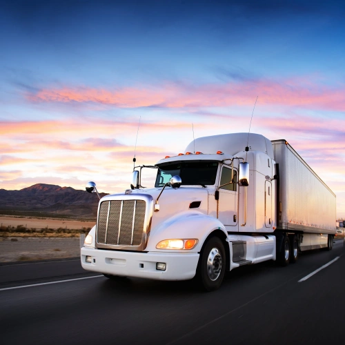 Semi truck on highway at sunset