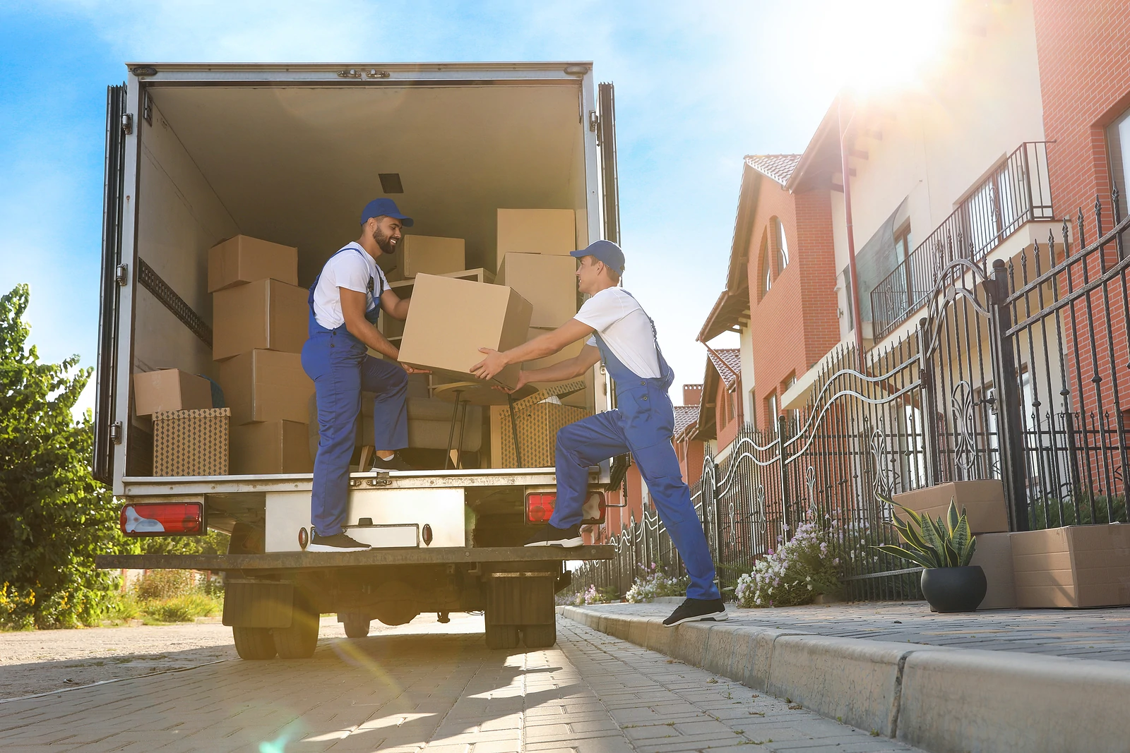 Workers unloading boxes from van